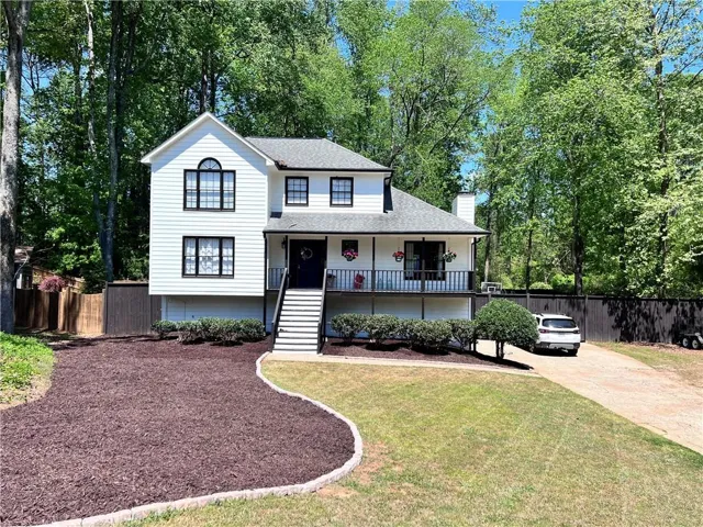 Contemporary white siding exterior with dark trim windows
