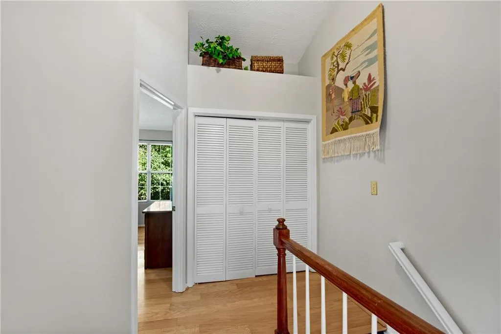 Hallway featuring hardwood / wood-style flooring Hallway featuring hardwood / wood-style flooring