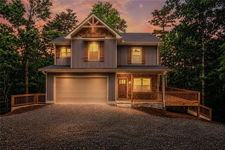 Craftsman-style exterior with board and batten siding, stone accents, and natural wood shutters