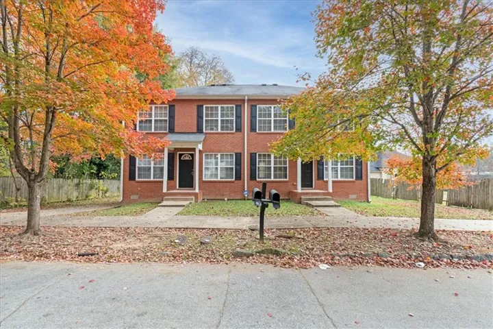 Brick exterior with multiple windows, each featuring black shutters