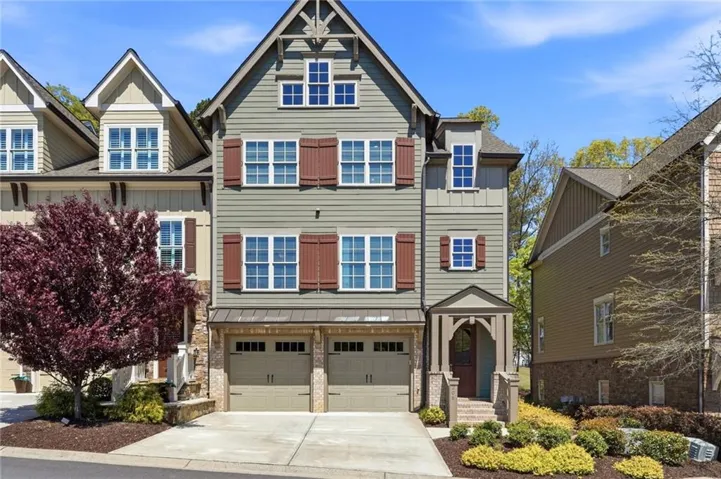 Craftsman inspired home featuring a garage, driveway, and board and batten siding