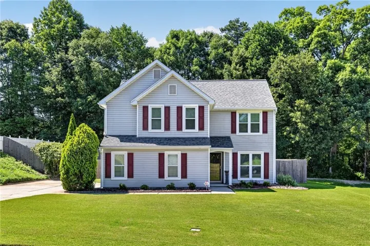 Stunning colonial-style home featuring vinyl siding, a charming front porch, and immaculate curb appeal. Located in a sought-after Grayson neighborhood with mature landscaping and a spacious side-entry garage.