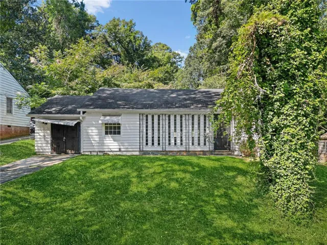 Exterior featuring horizontal siding, a gabled roofline, and a paved driveway