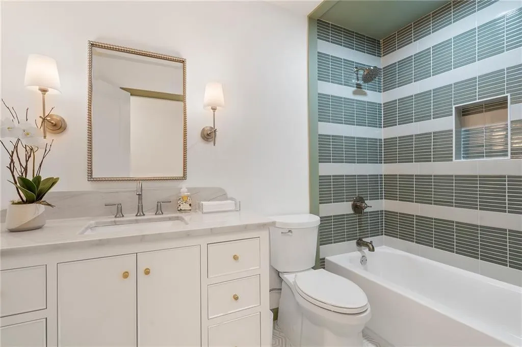 Hall bath features a tub