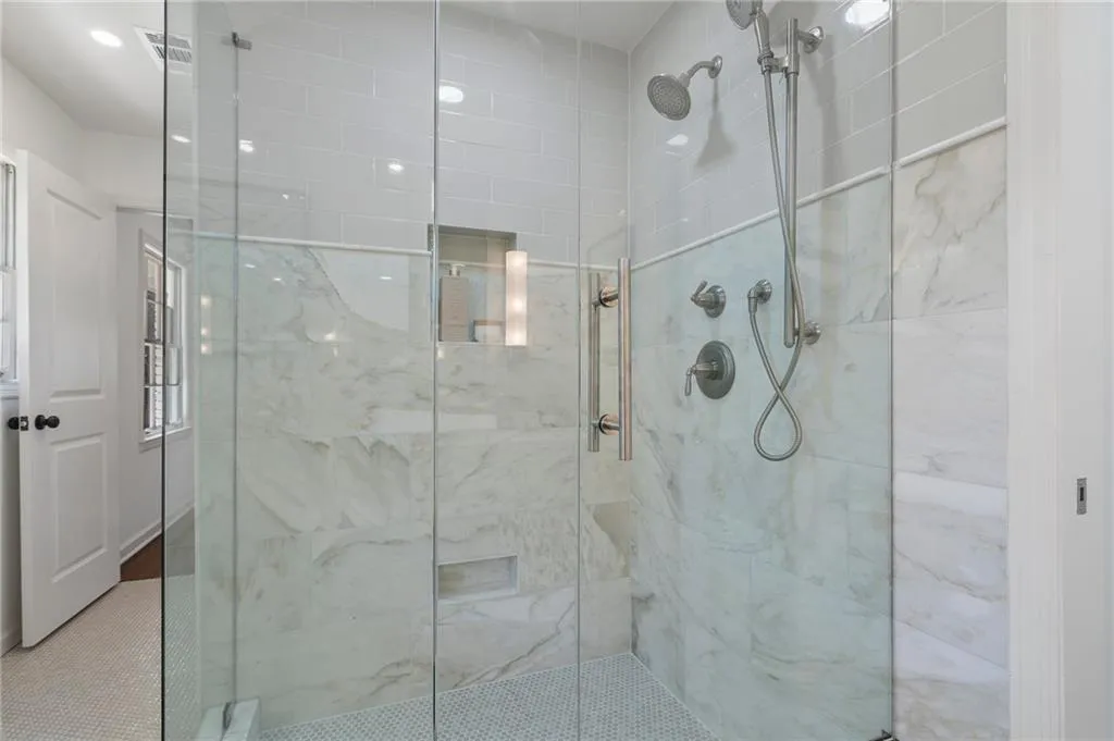 Standing shower features Calcutta marble tile