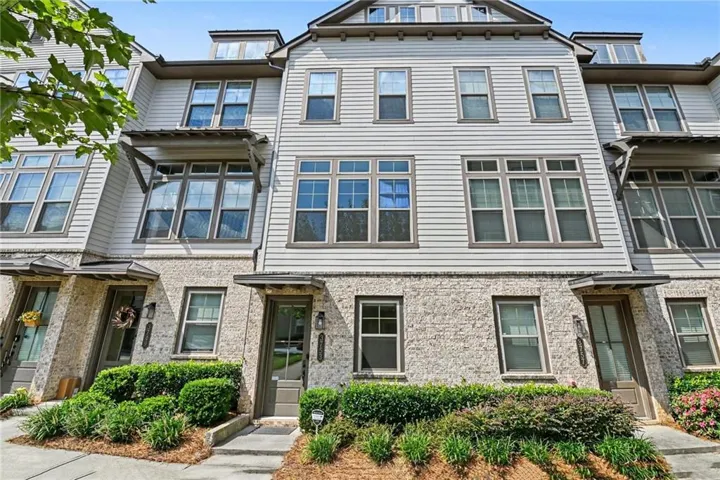 Multi-level townhome with stone and siding exterior
