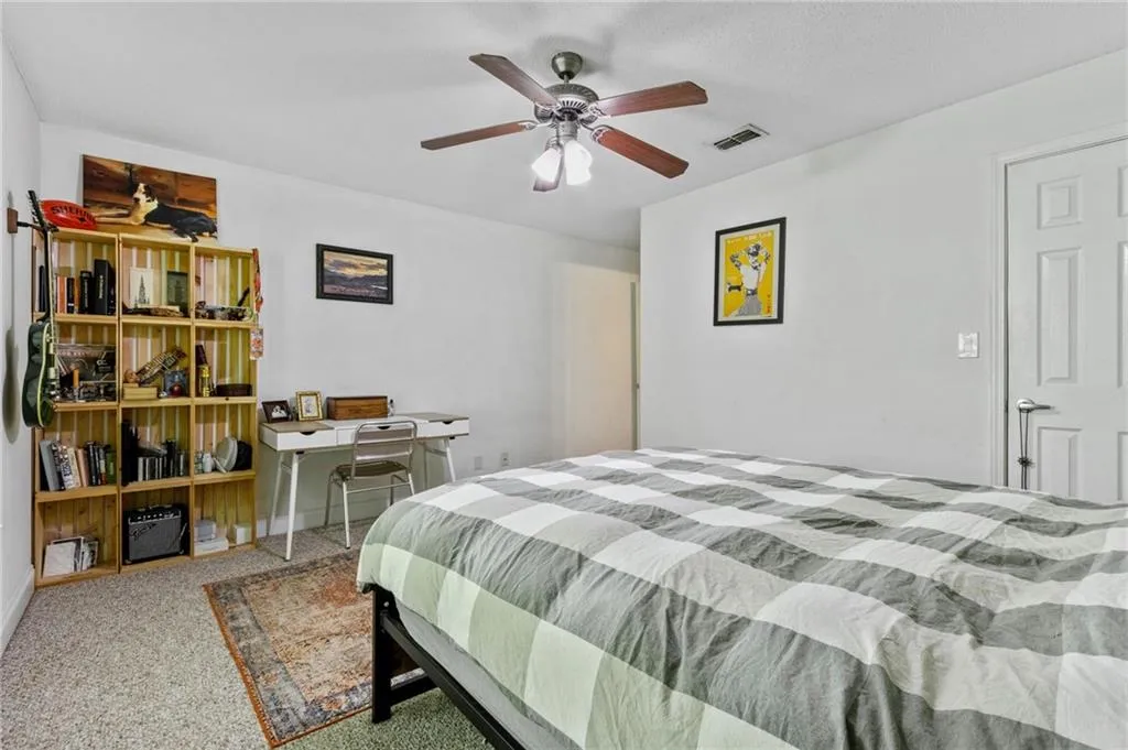 Carpeted bedroom with ceiling fan