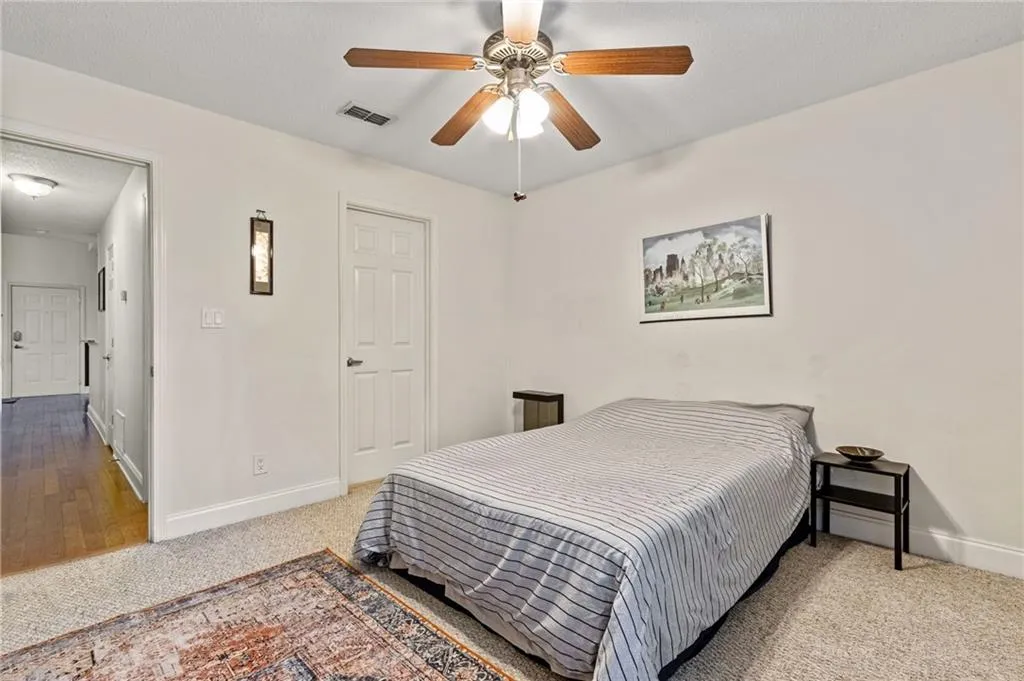 Bedroom featuring ceiling fan and carpet floors