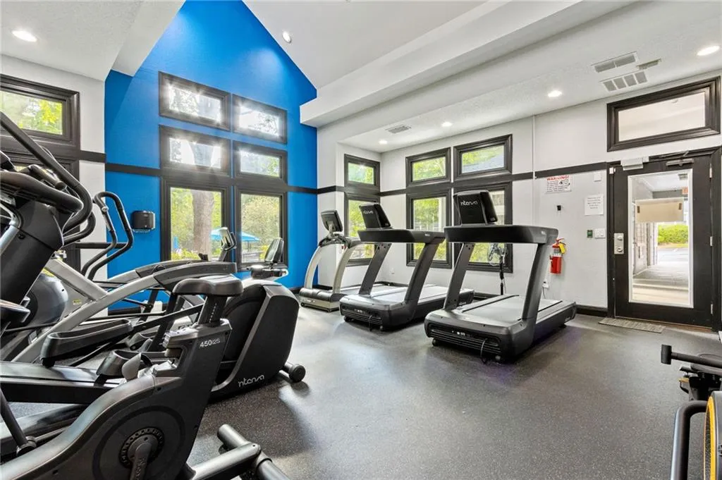 Workout area featuring a high ceiling and a textured ceiling