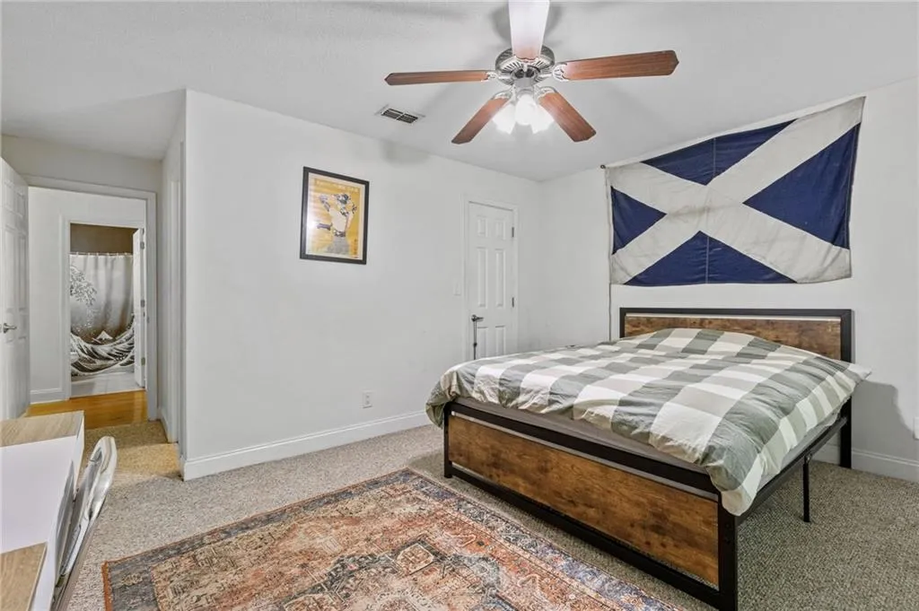 Carpeted bedroom with ceiling fan