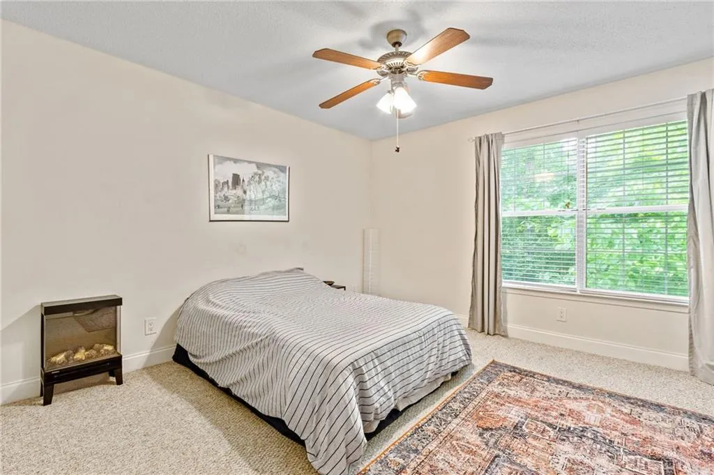 Bedroom with carpet and ceiling fan