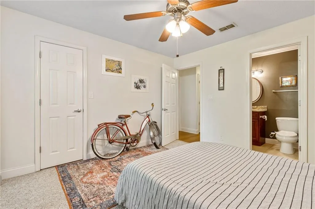Bedroom with ceiling fan and ensuite bathroom