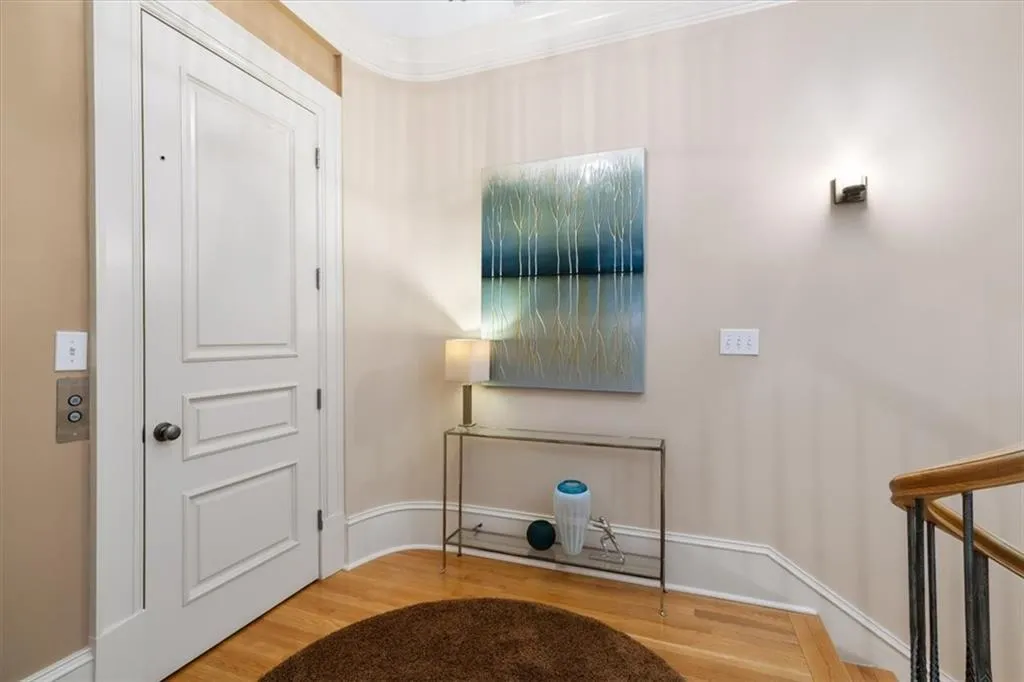 Entry into the Primary Suite from the stairs and the elevator