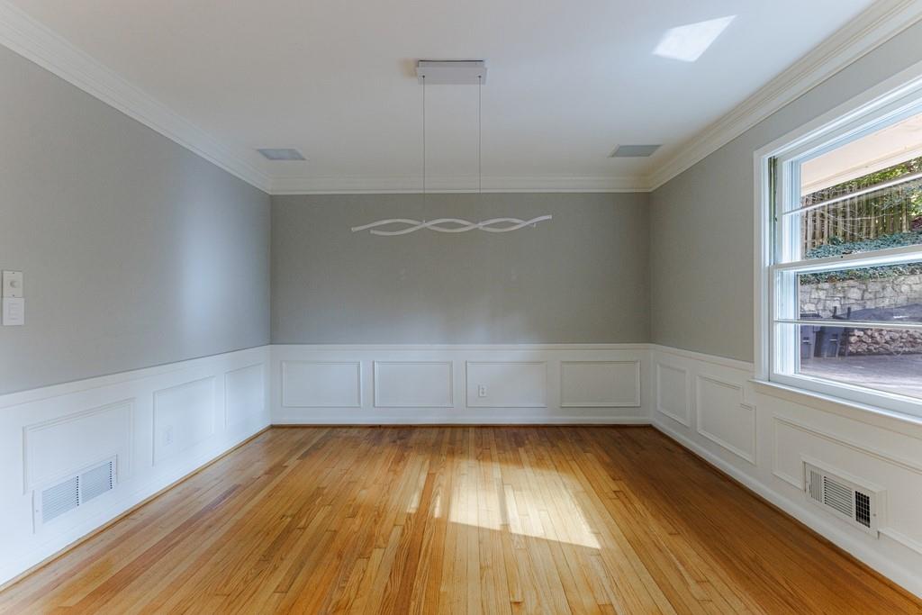 Separate dining room with gleaming hardwood floors