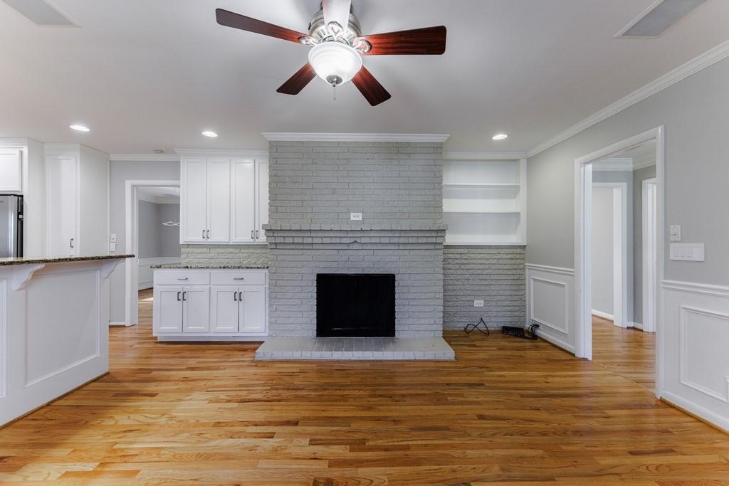 Family room with decorative fireplace and built-in bookshelves