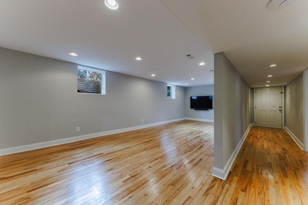 View of the recreation room and hallway to the 4th bedroom