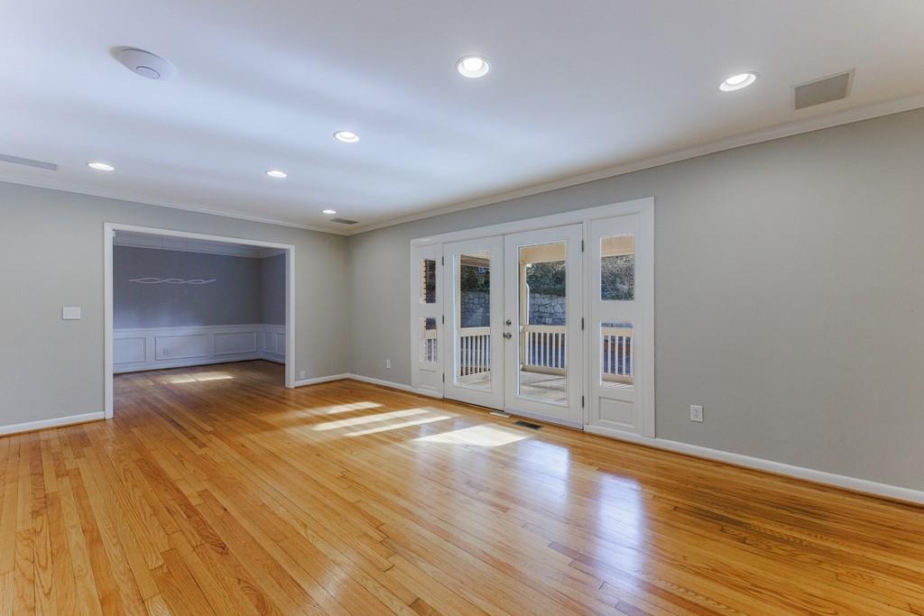 Large separate living room with glass French doors and gleaming hardwood floors