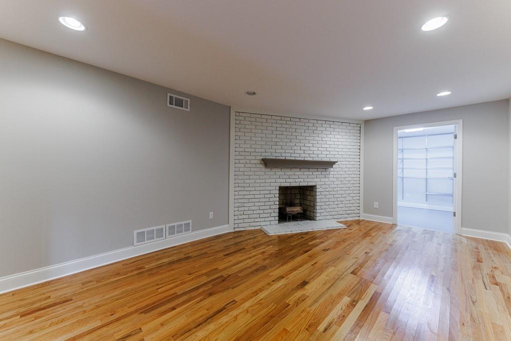 2nd playroom has a decorative fireplace plus a huge storage room