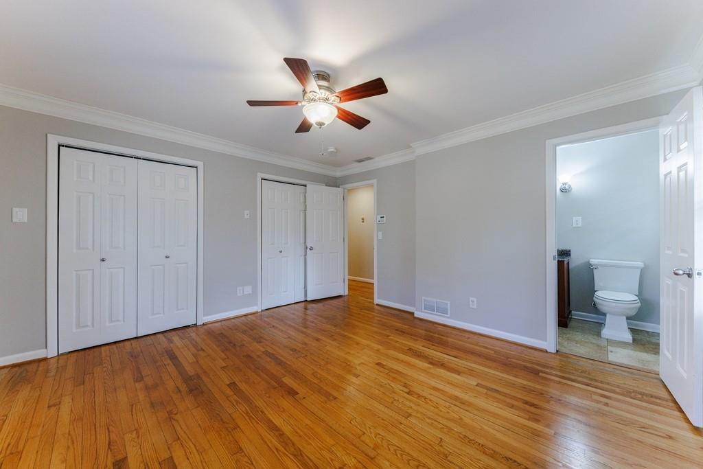 Primary bedroom on main level with two closets and en-suite bathroom