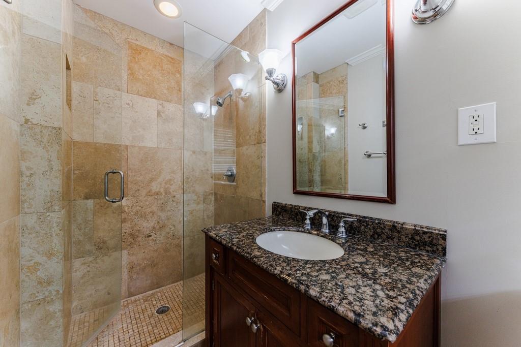 En-suite primary bathroom with glass shower door