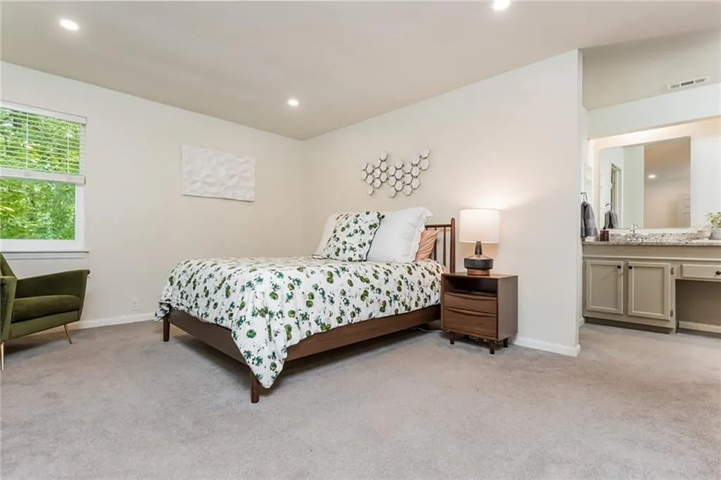Bedroom featuring sink and light colored carpet