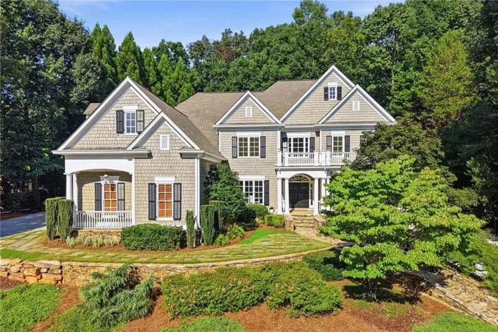 Traditional-style residence featuring shake siding and multiple gables