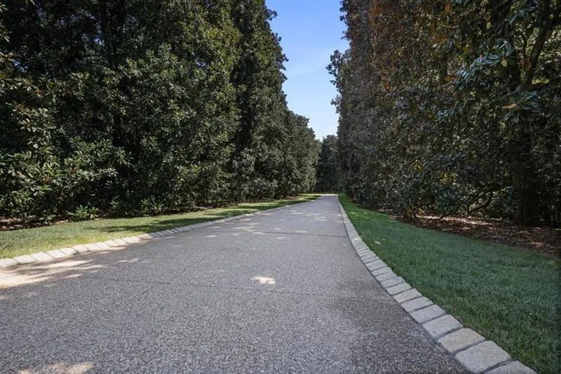 View of Long Driveway Leading toward Main Entrance and Tennis Court