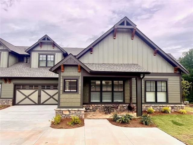 Craftsman-style exterior with board-and-batten siding, stone accents, and a covered porch