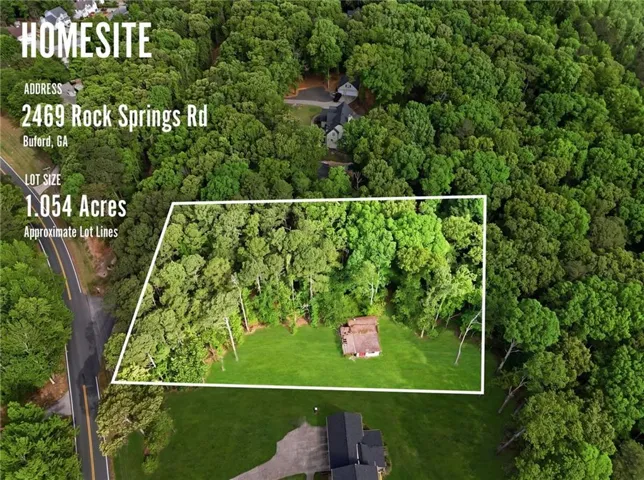 Expansive 1.054-acre lot featuring a combination of cleared green space and mature tree cover