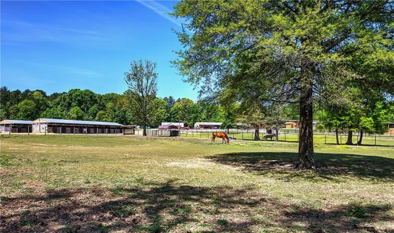 85 acres, fenced with barns, arena, home