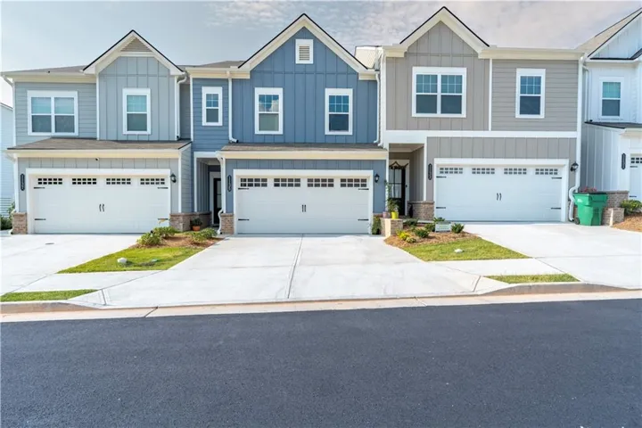 Craftsman house with driveway, board and batten siding, a garage, and a residential view