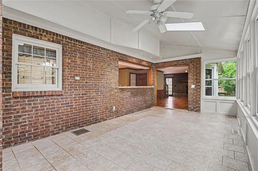 Beautiful Sunroom with Abundant Natural Light and Skylights with Bar Overlooking Kitchen & Open to Keeping Room