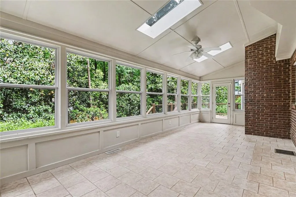 Beautiful Sunroom with Abundant Natural Light and Skylights Overlooking Backyard