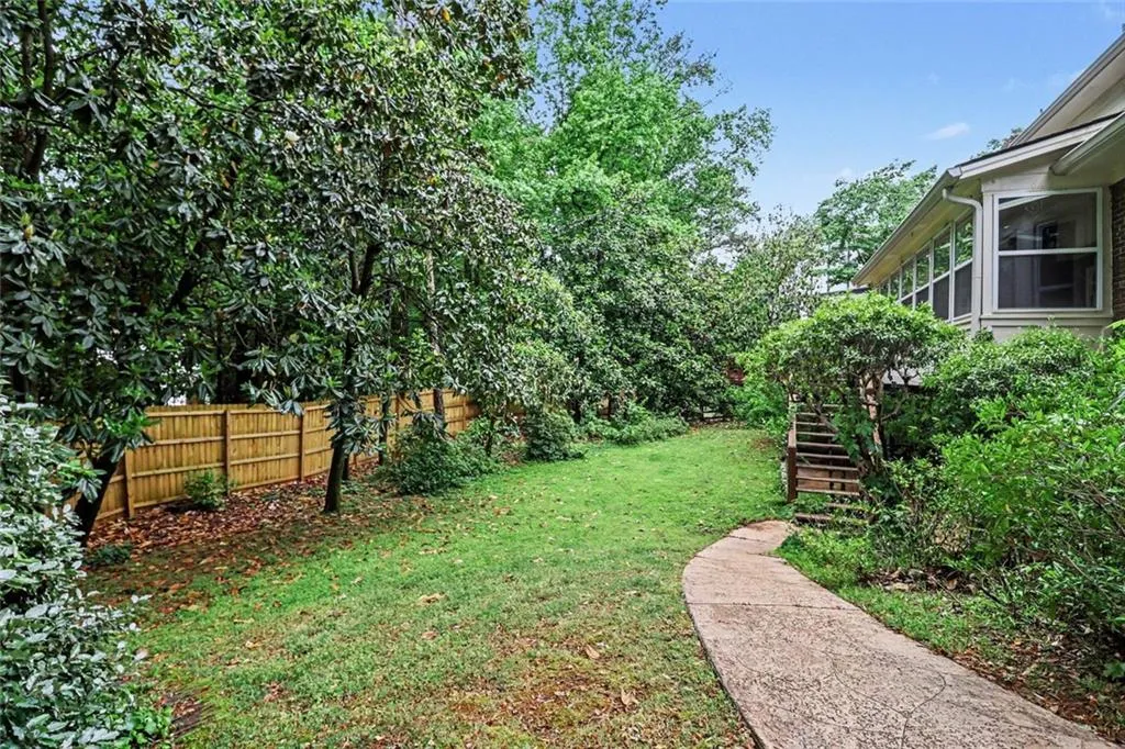 Level Backyard with Path to Lower Level Patio & Entrance to Terrace Level of Home