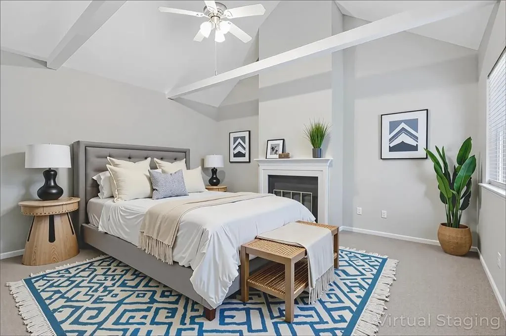 Bedroom with carpet, high vaulted ceiling, a glass covered fireplace, beamed ceiling, and ceiling fan