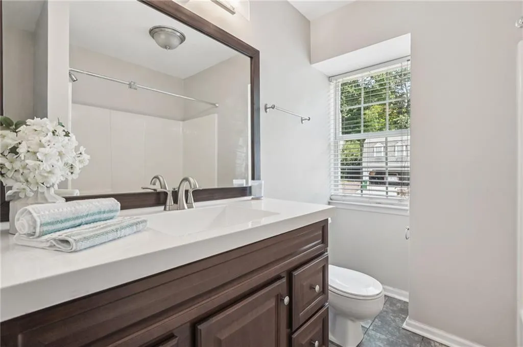Full bath with vanity, a shower, and tile patterned flooring
