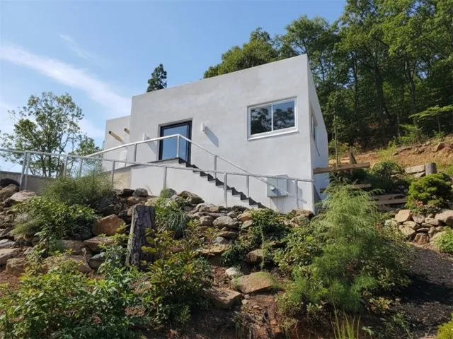 View of home's exterior featuring stairs and stucco siding