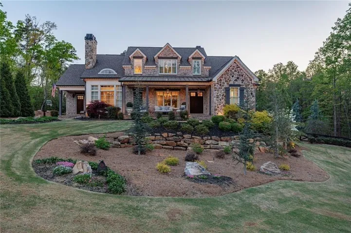 Brick and stone masterpiece on private acreage