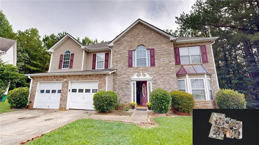 Brick and siding exterior with a two-car garage