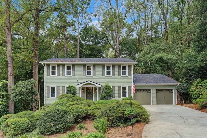 Two-story residential exterior with new Hardieplank siding. shutters, and a covered entryway