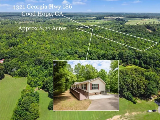 Expansive wooded acreage featuring a single-story residence with a tan exterior, red shutters, and an accessibility ramp
