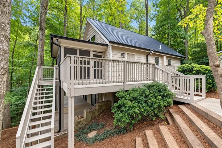 Light-toned siding exterior with a dark metal roof