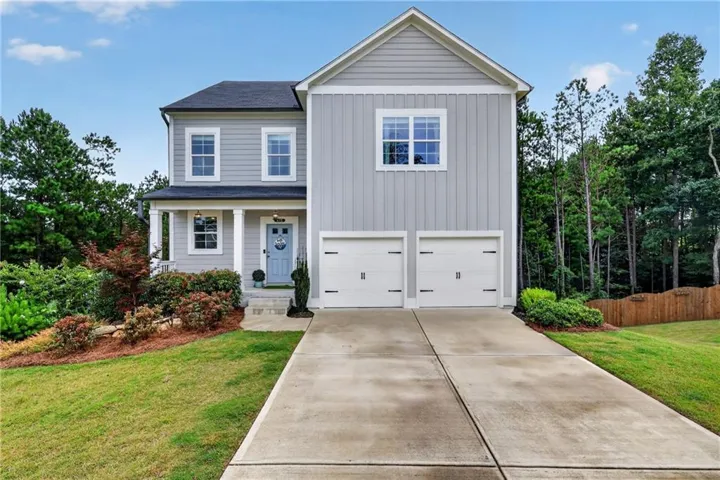 Contemporary two-story residence with light gray siding and white trim