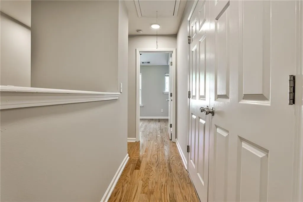Upstairs hallway connects the two bedrooms and features a conveniently located laundry closet behind double doors—designed for easy everyday living