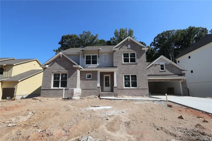 Two-story home with a brick and siding exterior, multiple gables, and an attached two-car garage