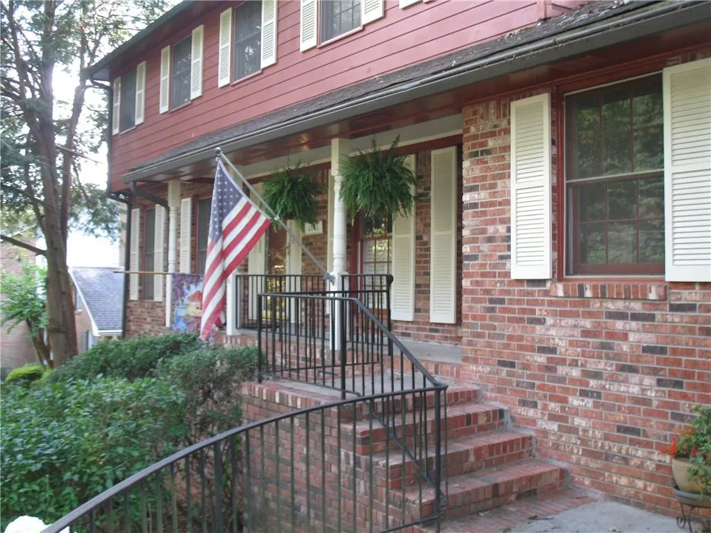 Entrance to property featuring brick siding