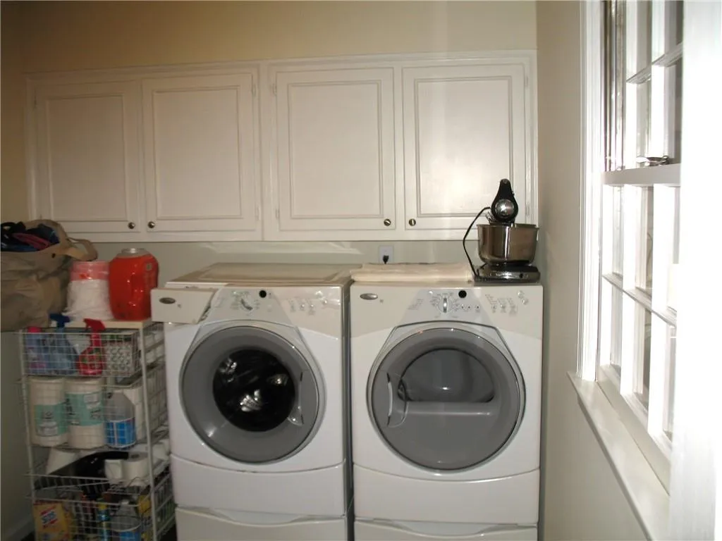 Separate large laundry room with plenty of storage and easy access to the outside.