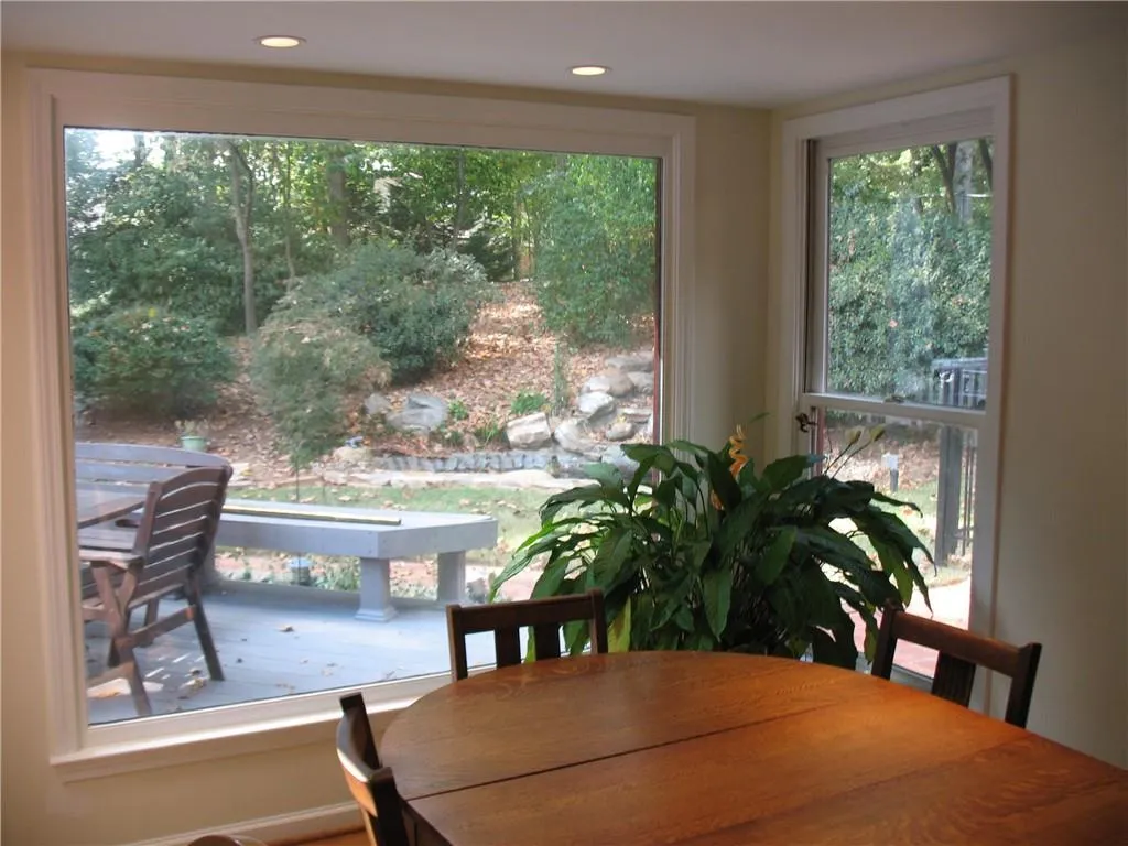 Kitchen eating area with a view to the large entertaining area on the deck. Overlooks the private backyard and pond
