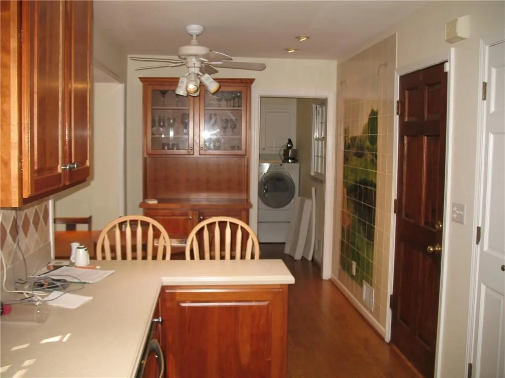 Dining area for kitchen adjoins the separate laundry room.