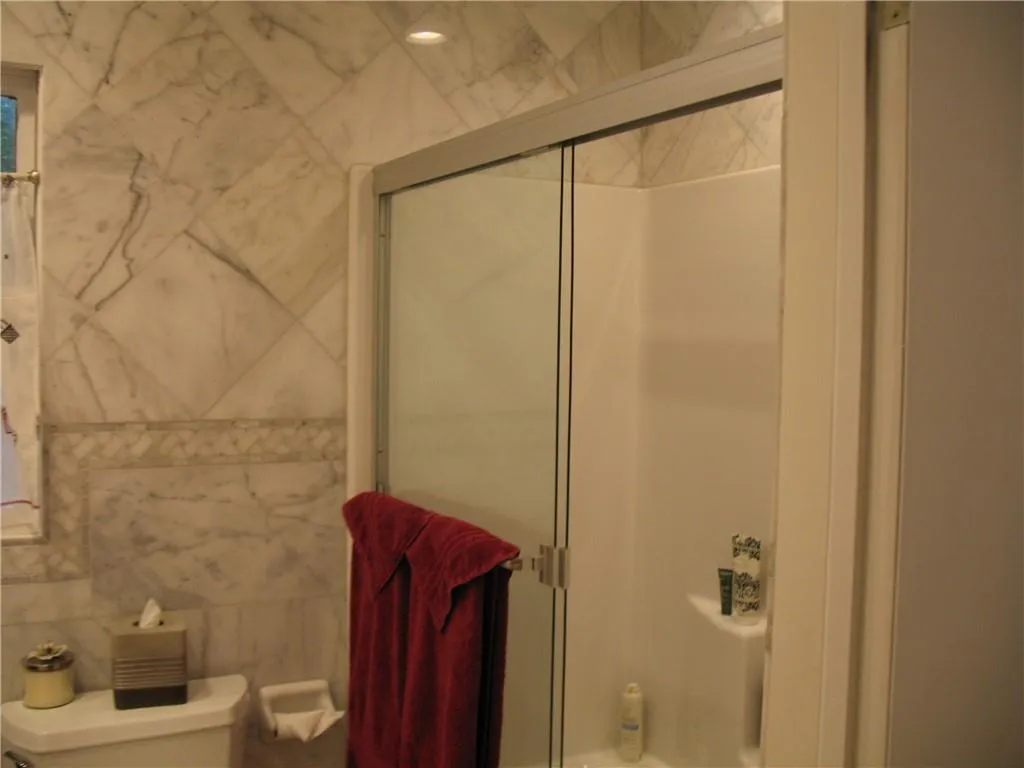 Full secondary bath adjoins bedroom and also allows access to the hall